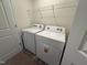 Bright laundry room featuring white washer and dryer, convenient shelving, and neutral flooring at 424 La Maison Ave # 9, Wendell, NC 27591
