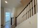Staircase with carpeted steps and white railings leads to the upper level at 424 La Maison Ave # 9, Wendell, NC 27591