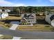 Aerial view of a two-story home featuring a driveway, landscaped yard, and mature trees enhancing privacy at 46 Two Belles Ct, Angier, NC 27501