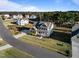 Aerial view of a two-story home with green trim and a three car garage at 46 Two Belles Ct, Angier, NC 27501