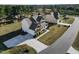 Aerial view of a two-story home featuring a driveway, landscaped yard, and mature trees enhancing privacy at 46 Two Belles Ct, Angier, NC 27501