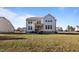 Back exterior featuring a spacious yard, patio, and second story deck of this two-story home at 46 Two Belles Ct, Angier, NC 27501
