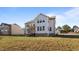 Exterior view of a two-story home, showcasing a large yard and adjacent neighboring houses at 46 Two Belles Ct, Angier, NC 27501