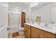 Bathroom featuring double sinks, wood cabinets, a shower and tub combination, and tile floors at 46 Two Belles Ct, Angier, NC 27501