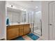 Bathroom featuring double sink vanity, framed mirror, and glass enclosed shower with a bench at 46 Two Belles Ct, Angier, NC 27501