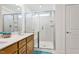 Bathroom featuring double sink vanity, framed mirror, and glass enclosed shower with a bench at 46 Two Belles Ct, Angier, NC 27501