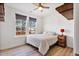 Cozy bedroom featuring two windows, ceiling fan, and wood-look flooring at 46 Two Belles Ct, Angier, NC 27501