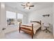 Bright bedroom with natural light, ceiling fan, carpet floors, and a wooden bed frame at 46 Two Belles Ct, Angier, NC 27501