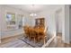 Bright dining room featuring a wooden table set, chandelier, and hardwood style flooring at 46 Two Belles Ct, Angier, NC 27501