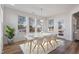 Bright dining room with a modern table set for six, with wood floors, and a large window for natural light at 46 Two Belles Ct, Angier, NC 27501