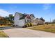 Side view of a two-story home featuring a two-car garage and a welcoming front porch with a landscaped yard at 46 Two Belles Ct, Angier, NC 27501