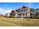 Charming two-story home featuring a welcoming front porch, and complemented by a beautifully landscaped yard at 46 Two Belles Ct, Angier, NC 27501