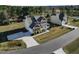 Charming two-story home featuring red accent details, a welcoming front porch and a long driveway at 46 Two Belles Ct, Angier, NC 27501
