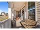 Inviting front porch with rocking chairs and a bench, perfect for relaxing and enjoying the neighborhood views at 46 Two Belles Ct, Angier, NC 27501