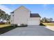 Side view of house with garage, concrete driveway, and manicured lawn at 46 Two Belles Ct, Angier, NC 27501