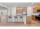 Bright kitchen with a large island, wood cabinets, stainless steel appliances, and breakfast bar seating at 46 Two Belles Ct, Angier, NC 27501