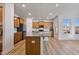 Spacious kitchen includes wood cabinets, granite counters, stainless appliances, island, and lots of natural light at 46 Two Belles Ct, Angier, NC 27501