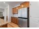 Bright kitchen featuring stainless refrigerator, granite countertops, and wood flooring at 46 Two Belles Ct, Angier, NC 27501