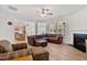 Bright living room featuring an open layout, fireplace, and comfortable seating arrangement at 46 Two Belles Ct, Angier, NC 27501