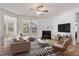 Cozy living room with a fireplace, comfortable seating, and large windows for natural light at 46 Two Belles Ct, Angier, NC 27501