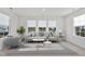 Bright living room with a neutral color palette, large windows, comfortable seating, and lots of natural light at 46 Two Belles Ct, Angier, NC 27501