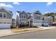 Street view of a two-story home with a two-car garage, set amongst similar houses at 504 Morning Glade St, Wake Forest, NC 27587