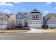 Charming two-story home with gray siding, white trim, and a two-car garage on a sunny day at 504 Morning Glade St, Wake Forest, NC 27587