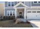 Close-up view of the front porch, showing the front door and a glimpse of the garage at 504 Morning Glade St, Wake Forest, NC 27587