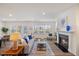 Inviting living room featuring a cozy fireplace, wood floors, and ample natural light at 504 Morning Glade St, Wake Forest, NC 27587