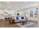 Bright living room featuring an open floor plan with modern furnishings and an adjacent kitchen area at 504 Morning Glade St, Wake Forest, NC 27587