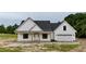 Charming single-story home featuring a covered front porch and attached garage at 6270 River Rd, Fuquay Varina, NC 27526