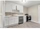 Updated kitchen with white cabinets, stainless steel appliances, and quartz countertops at 923 Belvedere St, Rocky Mount, NC 27803