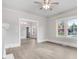 Spacious room features large windows, gray walls, white trim, and luxury vinyl plank flooring at 923 Belvedere St, Rocky Mount, NC 27803