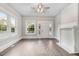 Bright living room with hardwood floors, fireplace, and large windows at 923 Belvedere St, Rocky Mount, NC 27803