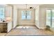 Sunny breakfast nook with modern chandelier and large windows, adjacent to the kitchen area at 2625 Silver Gate Ct, Wake Forest, NC 27587
