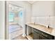View of butler's pantry leading into dining room, complete with white subway tile and countertop space at 2625 Silver Gate Ct, Wake Forest, NC 27587
