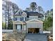Two-story home showcasing gray siding, black shutters, an attached garage, and a well-manicured lawn at 2625 Silver Gate Ct, Wake Forest, NC 27587