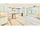 Bright kitchen featuring white cabinets, stainless steel appliances, and eat-in island with modern chandelier at 2625 Silver Gate Ct, Wake Forest, NC 27587