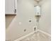 Functional laundry room with tiled floor, white cabinets, and modern black hardware at 2625 Silver Gate Ct, Wake Forest, NC 27587