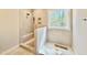 This walk-in shower features built in bench, tile surround, and a window at 2625 Silver Gate Ct, Wake Forest, NC 27587