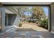 Back patio featuring a landscaped yard with mature trees and a glimpse of neighborhood homes at 3410 Bradley Pl, Raleigh, NC 27607