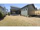 Backyard view of house featuring patio, manicured lawn, and green siding at 3410 Bradley Pl, Raleigh, NC 27607
