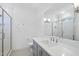 Bathroom with walk-in shower, gray vanity, undermount sink, and large mirror at 3410 Bradley Pl, Raleigh, NC 27607