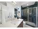 Modern bathroom with white countertops, dark tile shower, and upscale fixtures at 3410 Bradley Pl, Raleigh, NC 27607