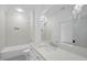 Bright bathroom featuring bathtub, tile, commode, vanity with mirror, and modern lighting at 3410 Bradley Pl, Raleigh, NC 27607
