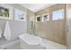 Modern bathroom featuring a standalone tub and seamless glass shower with multiple windows at 3410 Bradley Pl, Raleigh, NC 27607