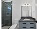 Contemporary bathroom featuring a glass-enclosed shower, gray vanity, and stylish mirror for a sleek aesthetic at 3410 Bradley Pl, Raleigh, NC 27607