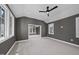 Spacious bedroom features neutral carpeting, tray ceilings, and natural light from several windows at 3410 Bradley Pl, Raleigh, NC 27607
