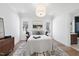 Well-lit bedroom with white walls, hardwood floors, a bed and an en suite bathroom at 3410 Bradley Pl, Raleigh, NC 27607