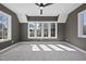 Carpeted bedroom boasts modern ceiling fan and plenty of natural light from the triple windows at 3410 Bradley Pl, Raleigh, NC 27607